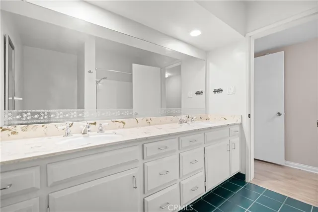 a bathroom with a double vanity sink and mirror