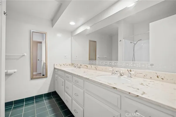 a bathroom with a double vanity sink mirror and