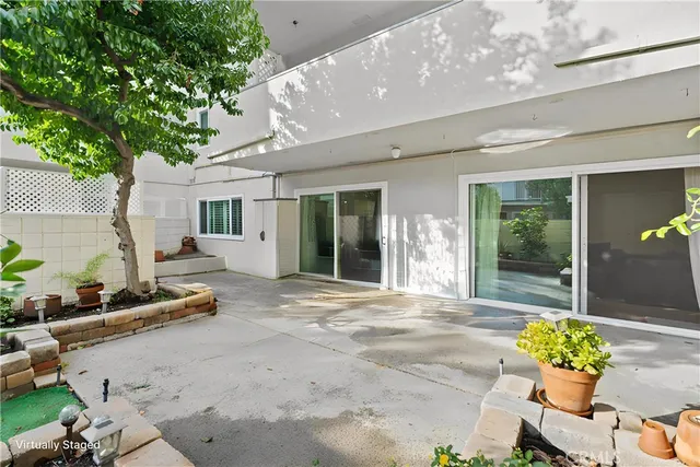 a front view of a house with a garden and patio