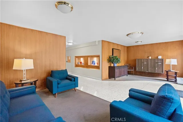 a living room with furniture and a lamp