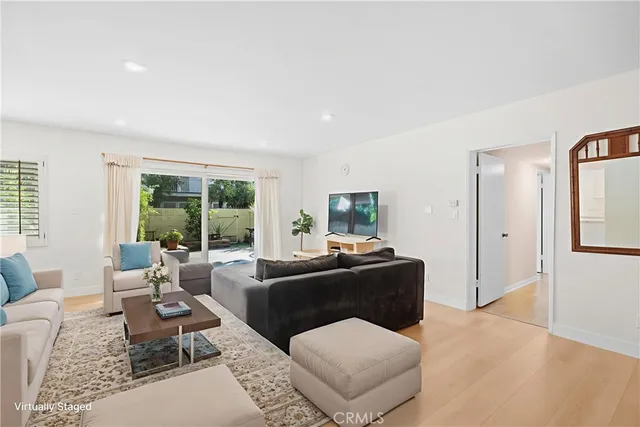 a living room with furniture large window and a table