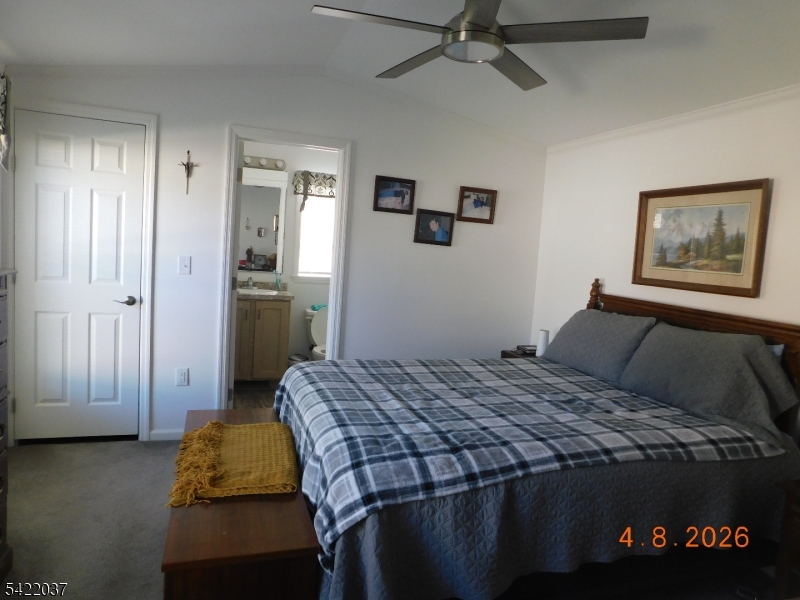 89 Back Street Oxford, NJ 07863 - Photo 15 of 17 a bedroom with a bed and a chandelier