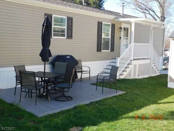 a view of a house with backyard and a sitting area