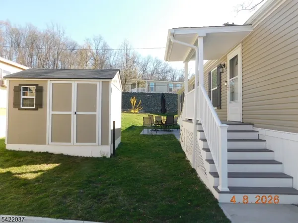 a view of a house with backyard and porch