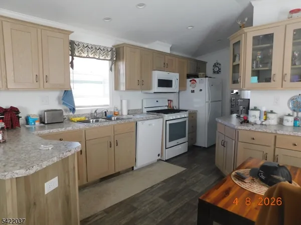 a kitchen with a sink stove top oven and microwave