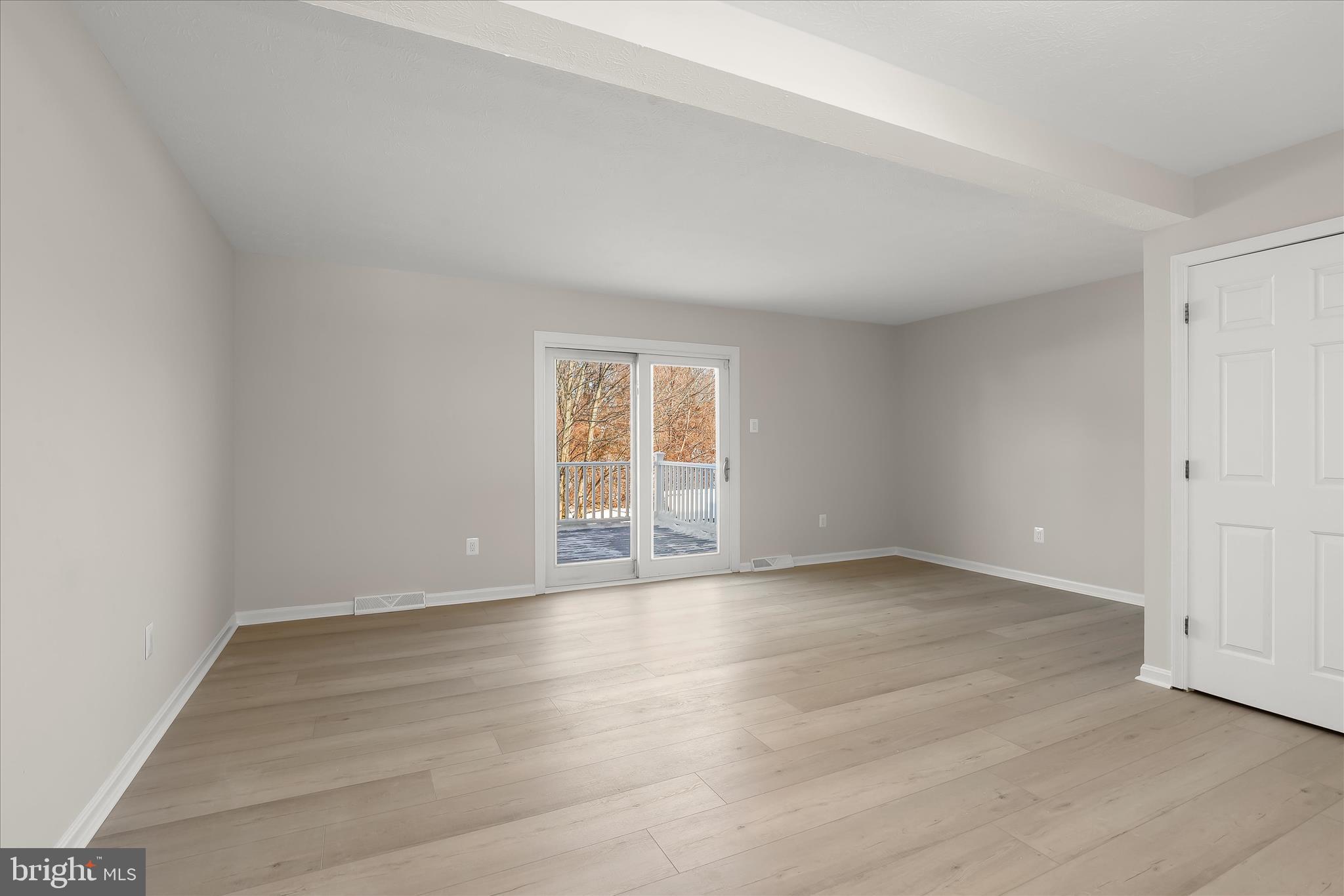 893 Century Street Hampstead, MD 21074 - Photo 11 of 42 an empty room with wooden floor and windows