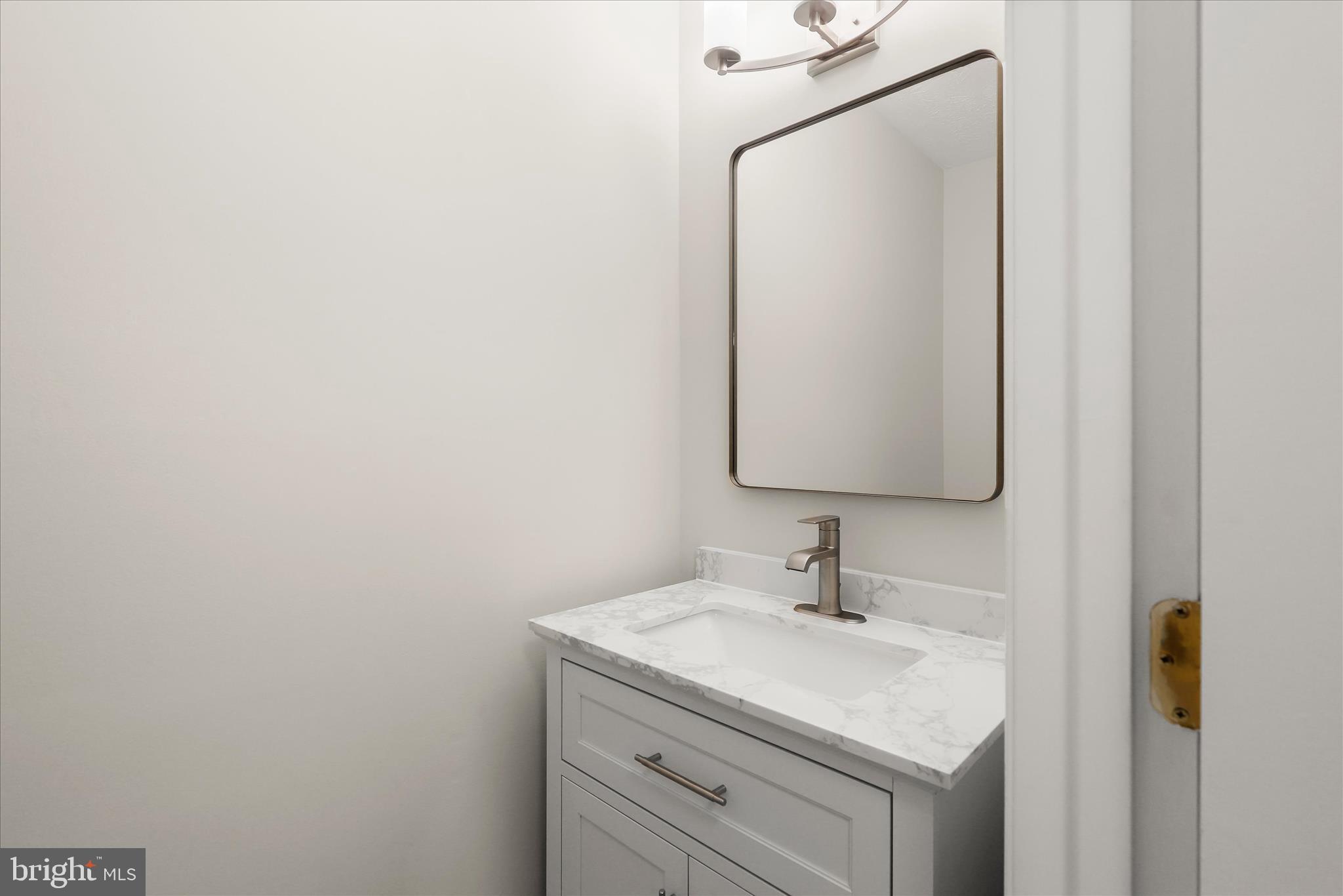 893 Century Street Hampstead, MD 21074 - Photo 16 of 42 a bathroom with a sink and a mirror