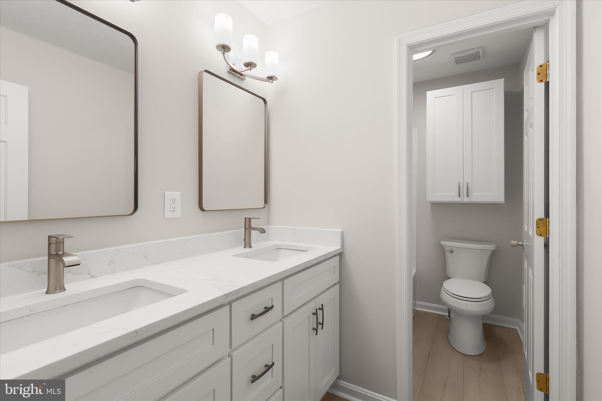 893 Century Street Hampstead, MD 21074 - Photo 23 of 42 a bathroom with a toilet sink and mirror