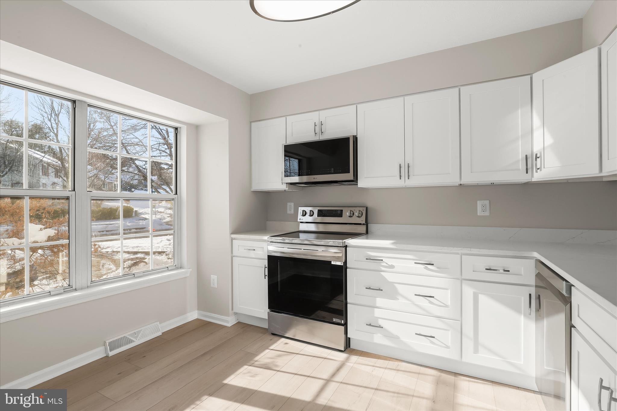 893 Century Street Hampstead, MD 21074 - Photo 5 of 42 a kitchen with granite countertop a stove a sink and a microwave