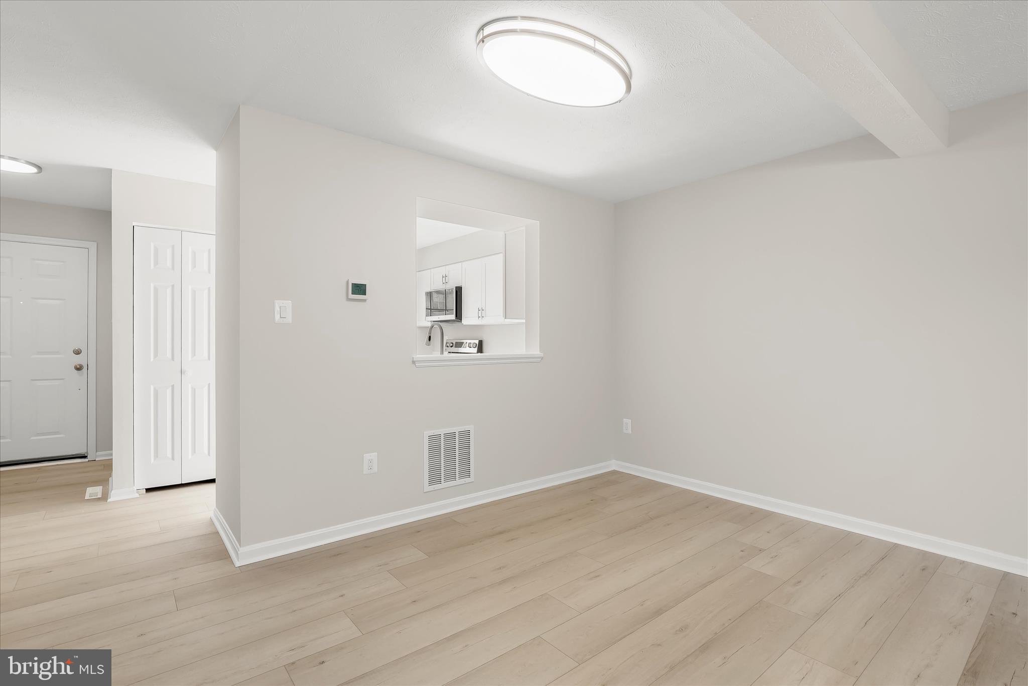 893 Century Street Hampstead, MD 21074 - Photo 8 of 42 an empty room with wooden floor and windows