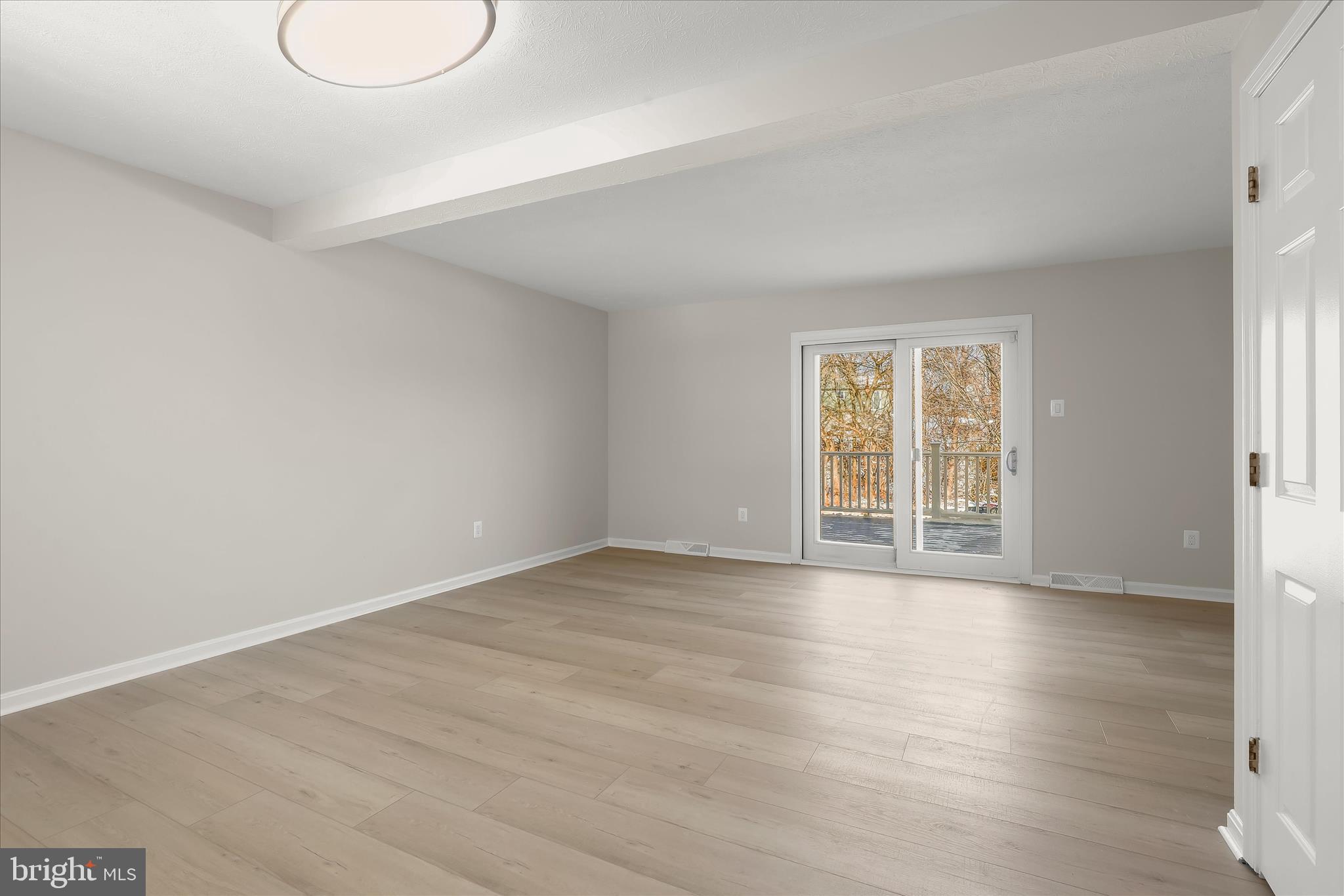 893 Century Street Hampstead, MD 21074 - Photo 37 of 42 a view of an empty room with wooden floor and a window