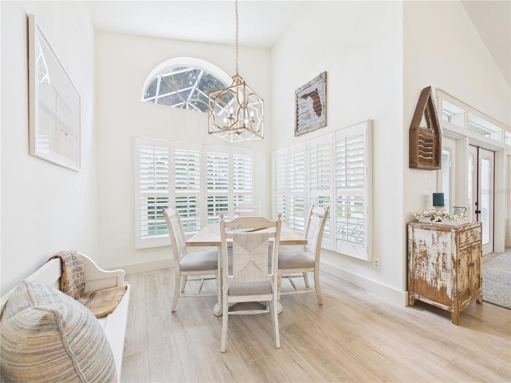426 Long Cove Road Ormond Beach, FL 32174 - Photo 19 of 73 a dining room with furniture and wooden floor