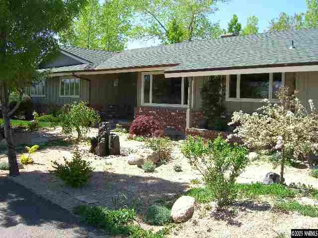 3450 Quilici Road Reno, NV 89511 - Photo 1 of 8 a front view of house with yard and green space