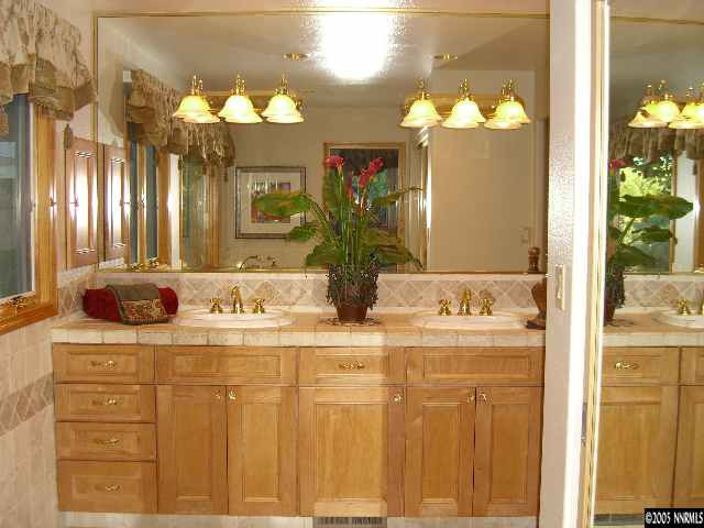 3450 Quilici Road Reno, NV 89511 - Photo 5 of 8 a bathroom with a double vanity sink and a mirror