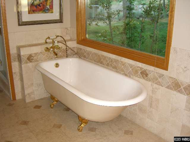 3450 Quilici Road Reno, NV 89511 - Photo 6 of 8 a white bath tub sitting in a bathroom
