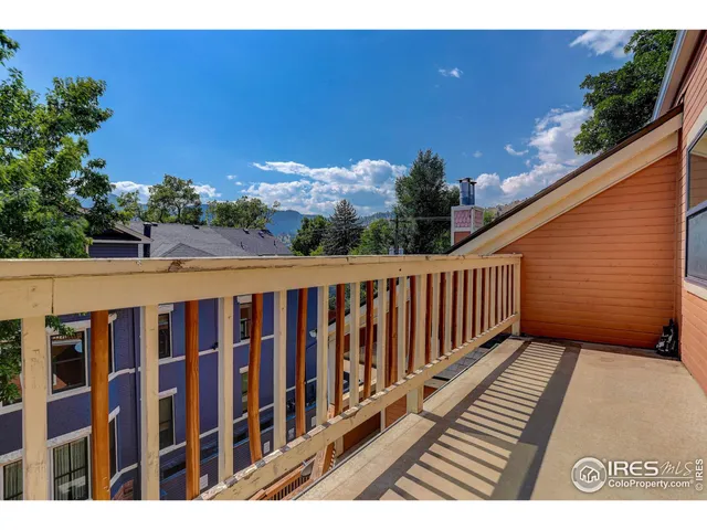 a balcony with wooden floor and outdoor space