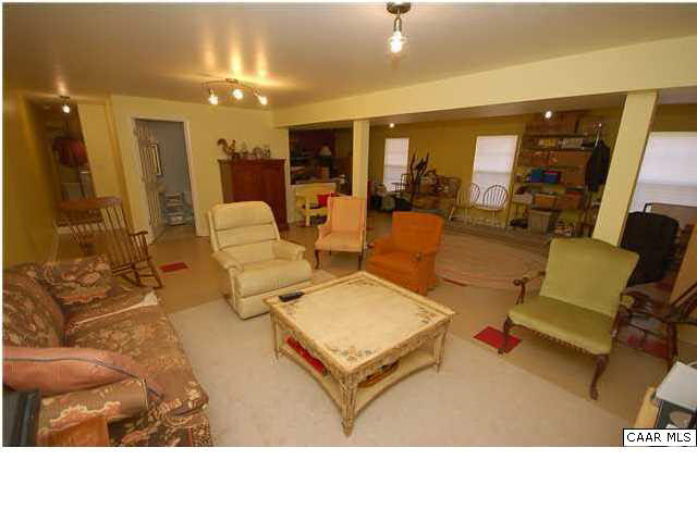 545 Jonquil Road Ruckersville, VA 22968 - Photo 23 of 26 a living room with furniture and a large mirror