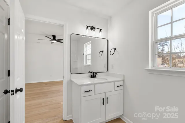a bathroom with a sink a mirror and window