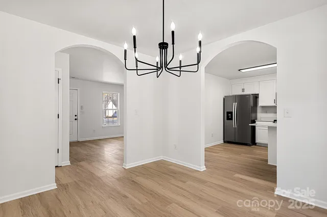a view of a room with wooden floor and white walls