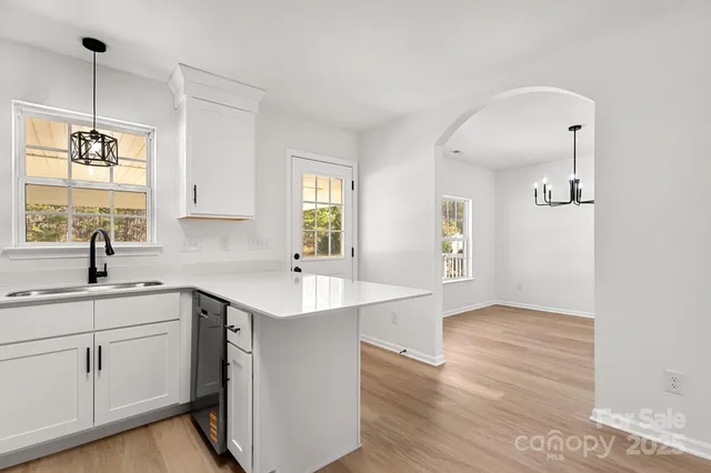 a kitchen with a sink cabinets and window