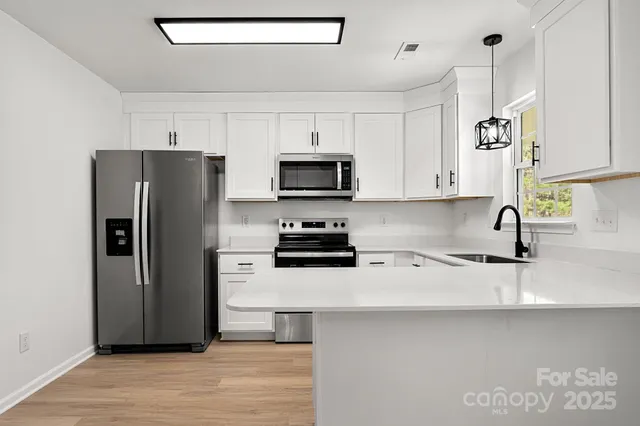 a kitchen with a refrigerator and a sink