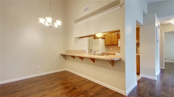 a view of room with wooden floor