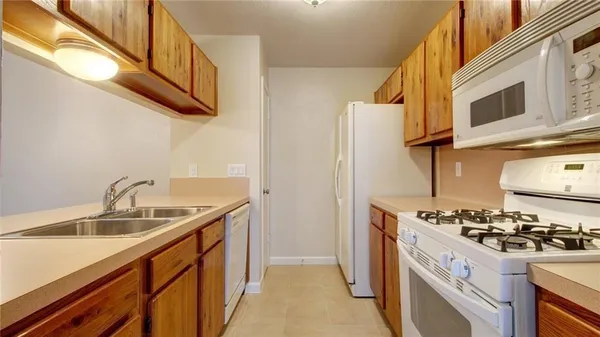 a kitchen with stainless steel appliances granite countertop a sink and a stove