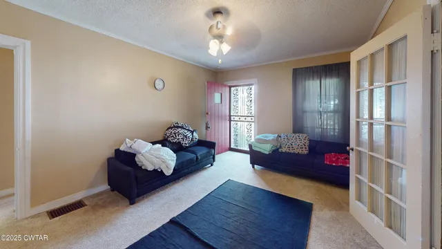 a living room with furniture and a chandelier