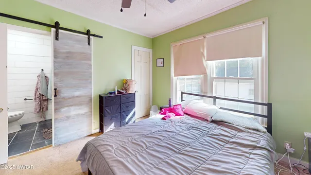 a bedroom with a bed and a window