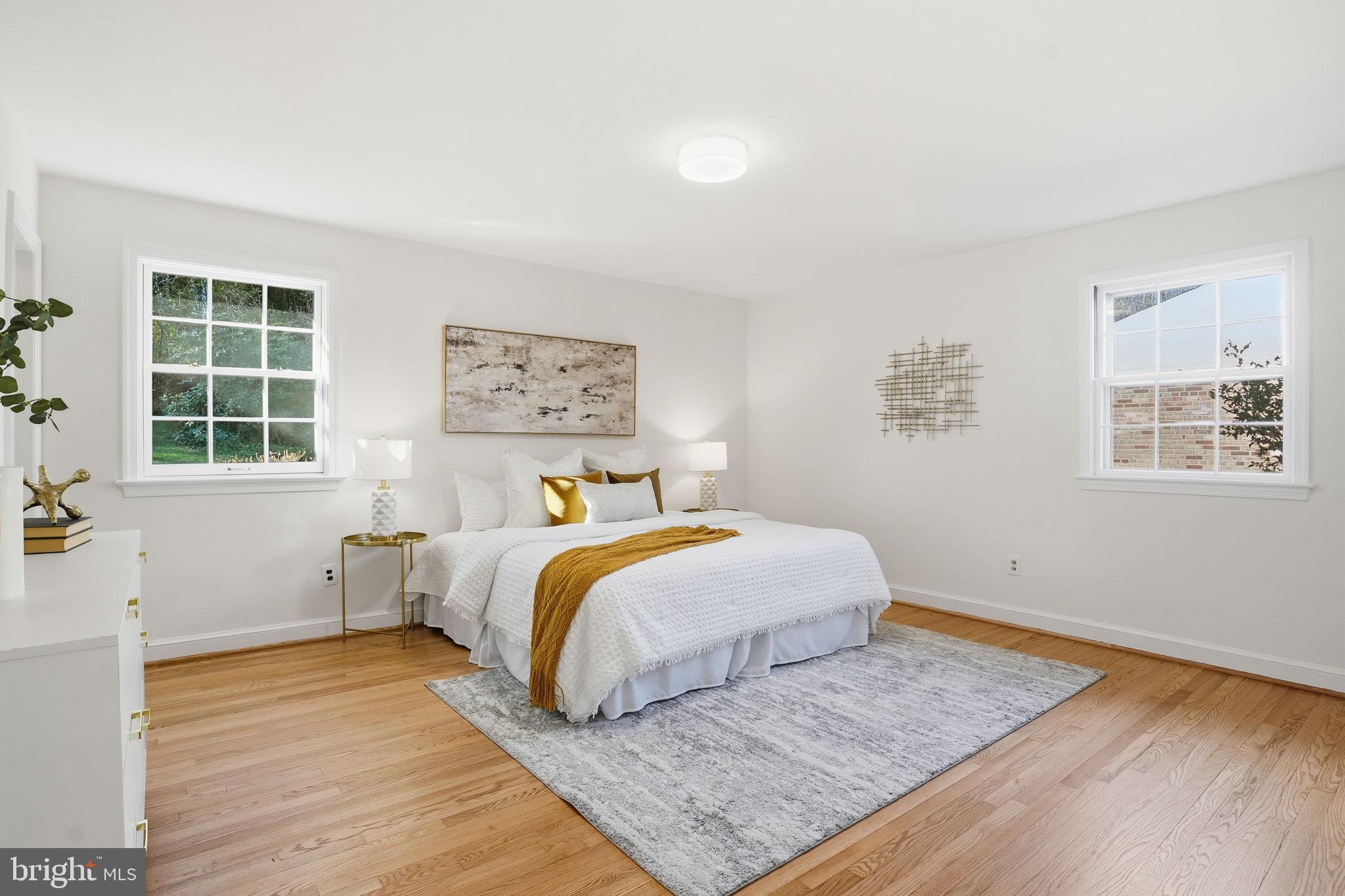 8200 Beech Tree Road Bethesda, MD 20817 - Photo 13 of 29 a bedroom with a bed and wooden floor