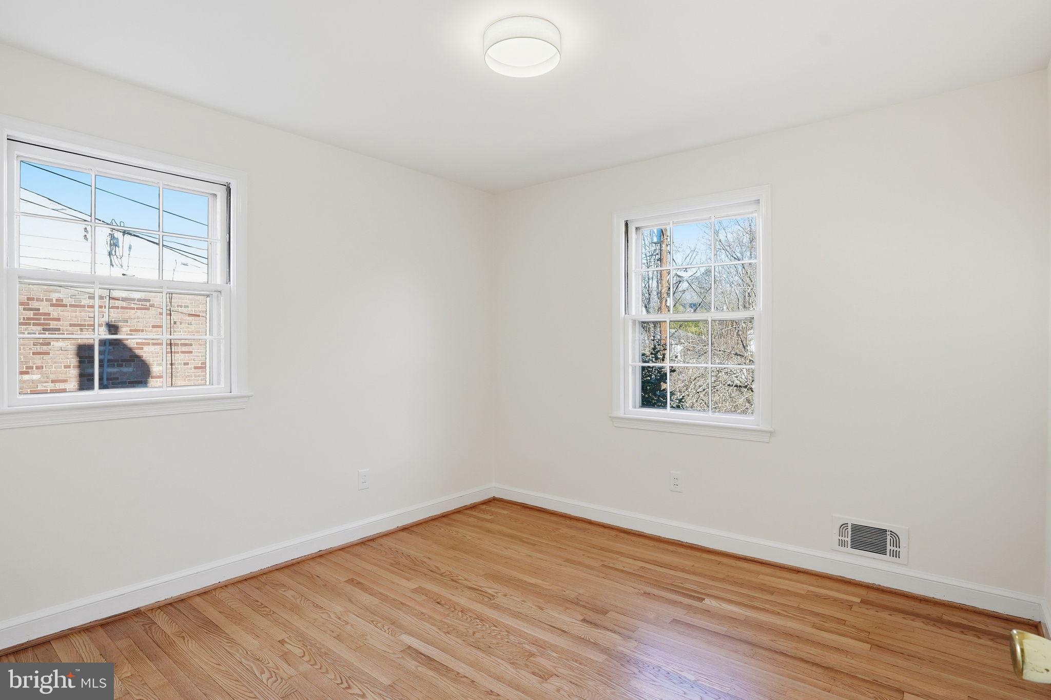 8200 Beech Tree Road Bethesda, MD 20817 - Photo 16 of 29 an empty room with wooden floor and windows