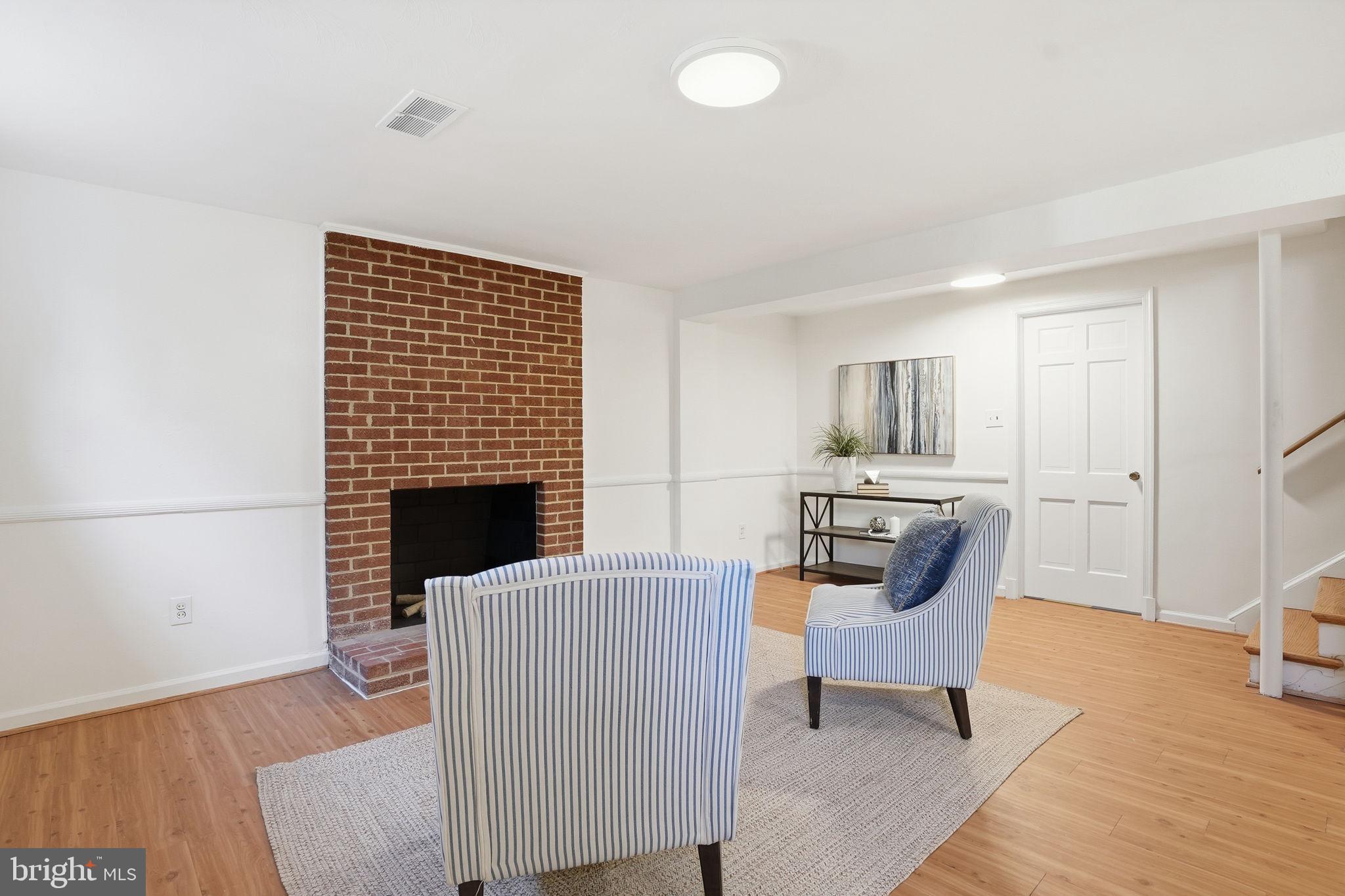 8200 Beech Tree Road Bethesda, MD 20817 - Photo 21 of 29 a living room with furniture wooden floor and a fireplace