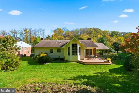 a front view of a house with a yard table and chairs