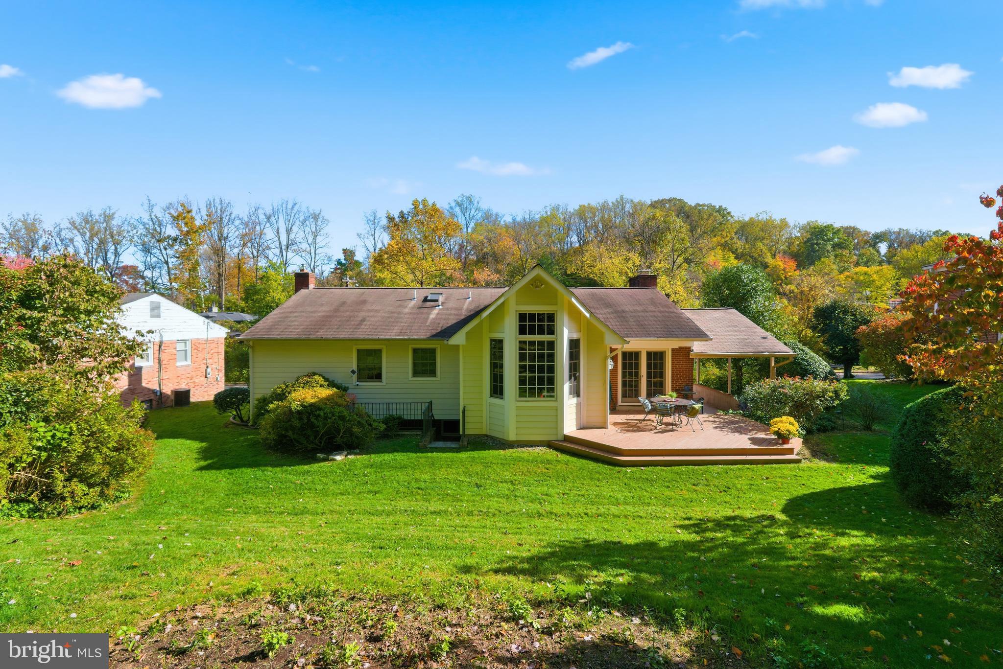 8200 Beech Tree Road Bethesda, MD 20817 - Photo 28 of 29 a front view of a house with a yard table and chairs