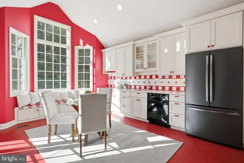 a dining room with furniture a fireplace and wooden floor