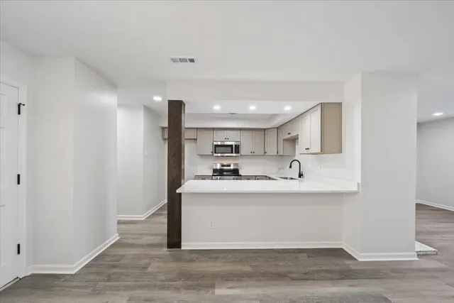 a view of kitchen with stainless steel appliances granite countertop refrigerator sink and stove