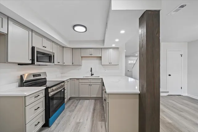 a kitchen with stainless steel appliances granite countertop a sink stove and refrigerator