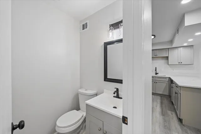 a bathroom with a toilet a sink and mirror