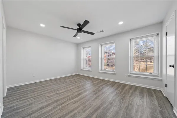 wooden floor in an empty room with a window
