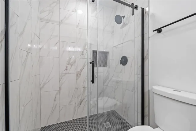 a bathroom with a shower and toilet