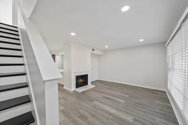wooden floor in an empty room with a fireplace