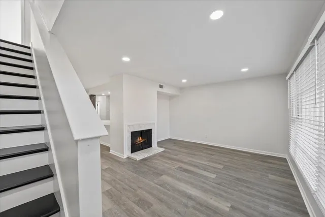 wooden floor in an empty room with a fireplace