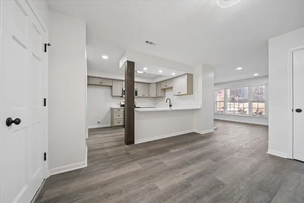 a view of a kitchen with a refrigerator and a sink