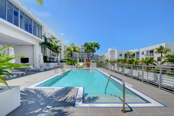 a swimming pool with outdoor seating and yard