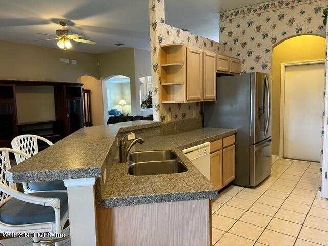 10321 Sugar Grove Road Jacksonville, FL 32221 - Photo 15 of 34 a kitchen with a sink a refrigerator and chandelier