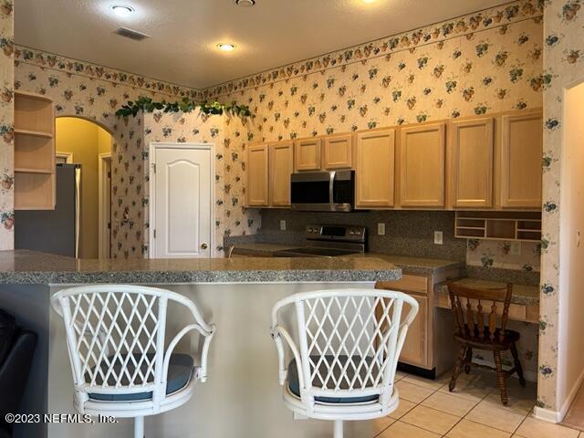 10321 Sugar Grove Road Jacksonville, FL 32221 - Photo 17 of 34 a kitchen with granite countertop a sink and a microwave