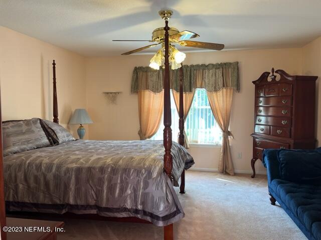 10321 Sugar Grove Road Jacksonville, FL 32221 - Photo 20 of 34 a bedroom with a bed a window and dresser