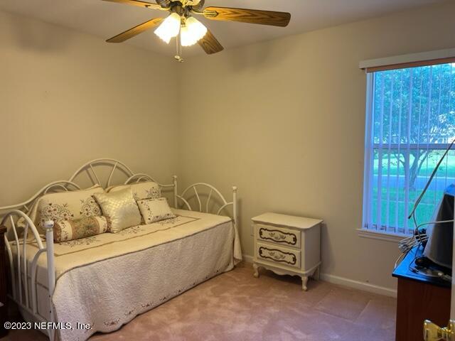 10321 Sugar Grove Road Jacksonville, FL 32221 - Photo 27 of 34 a bedroom with a bed and a tv