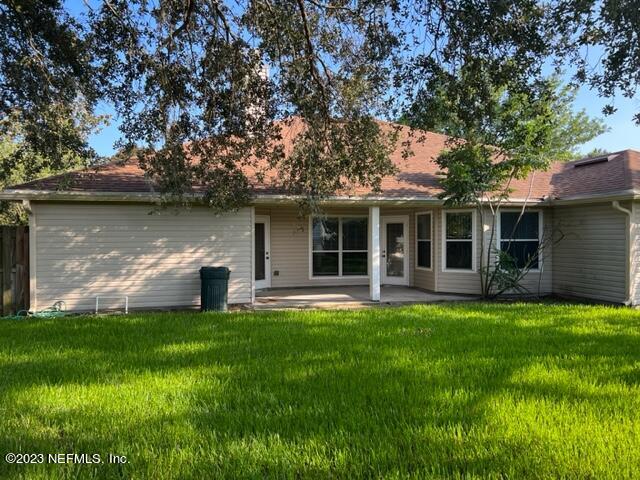 10321 Sugar Grove Road Jacksonville, FL 32221 - Photo 30 of 34 a front view of a house with a garden and yard
