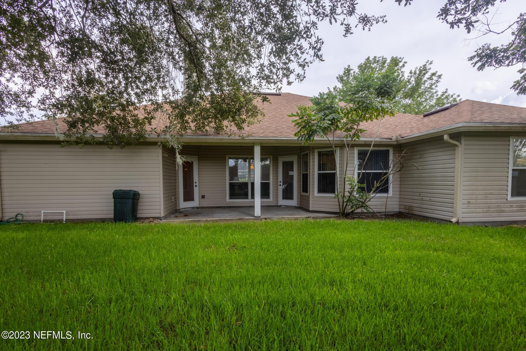 10321 Sugar Grove Road Jacksonville, FL 32221 - Photo 32 of 34 a view of a house with a yard and sitting area